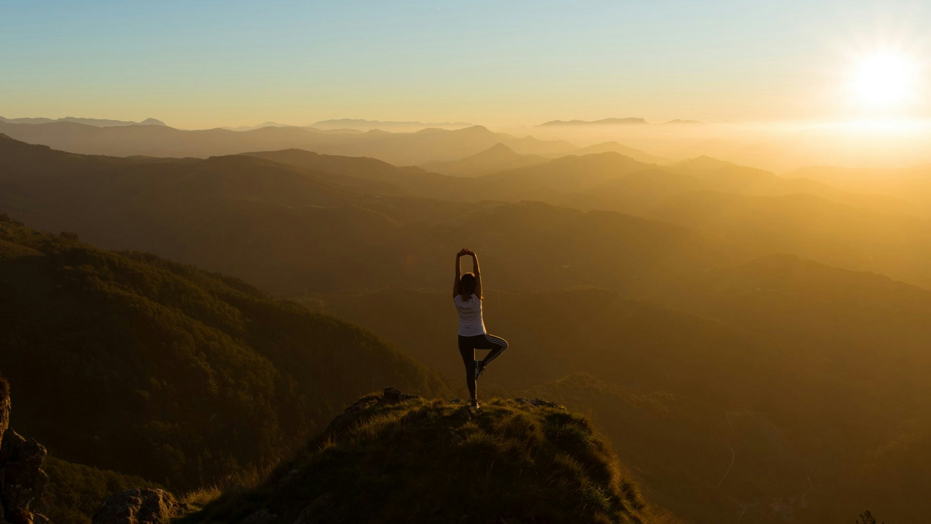 yoga atop a mountain